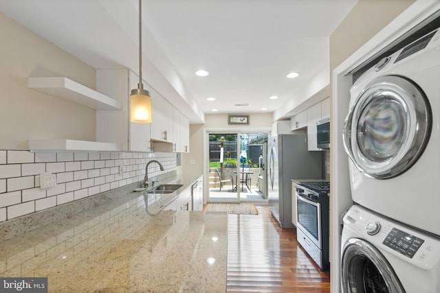 3343 Paine St, Baltimore, MD 21211 - kitchen with open shelves, stainless steel appliances, stacked washer / dryer, white cabinetry, and recessed lighting