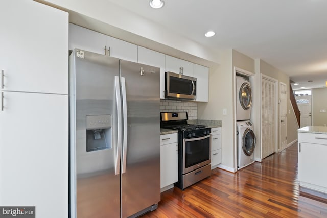 3343 Paine St, Baltimore, MD 21211 - kitchen featuring appliances with stainless steel finishes, stacked washer / drying machine, dark wood-style floors, white cabinetry, and recessed lighting
