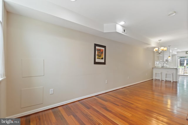3343 Paine St, Baltimore, MD 21211 - spare room featuring a chandelier, wood finished floors, a smoke detector, and recessed lighting