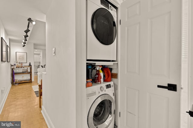 1811 19th St NW Unit 2, Washington, DC 20009 - laundry room featuring stacked washer / dryer and rail lighting