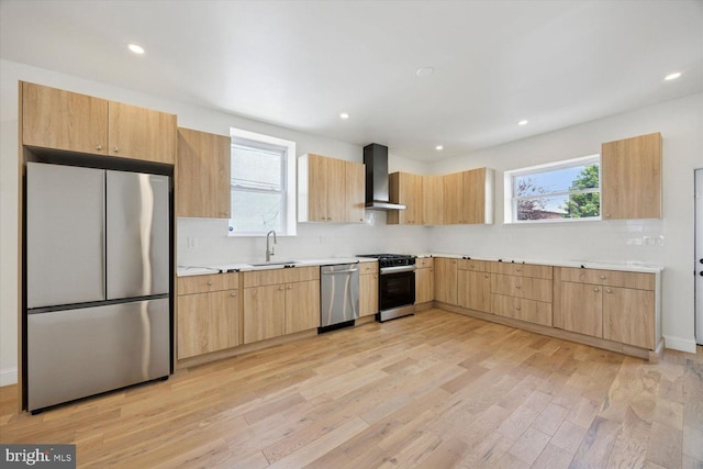 4063 Spring Garden St, Philadelphia, PA 19104 - kitchen with appliances with stainless steel finishes, wall chimney exhaust hood, light wood-type flooring, light brown cabinets, and recessed lighting