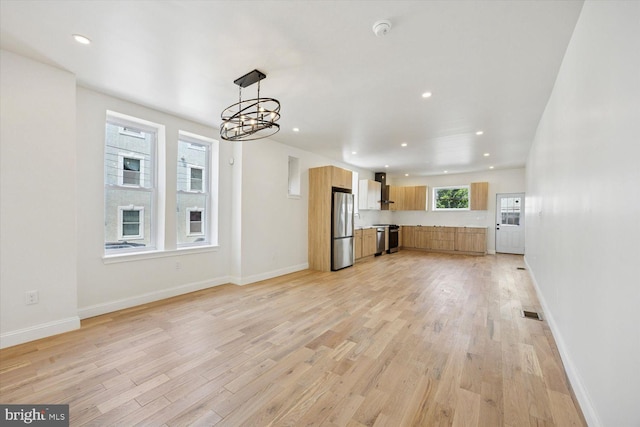 4063 Spring Garden St, Philadelphia, PA 19104 - unfurnished living room featuring light wood finished floors, a chandelier, and recessed lighting