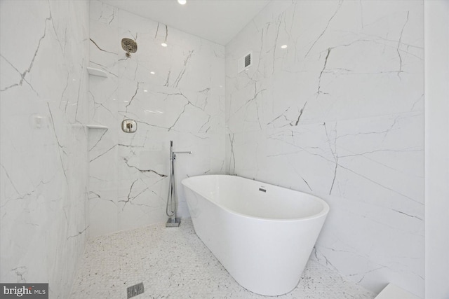 4063 Spring Garden St, Philadelphia, PA 19104 - full bathroom with a marble finish shower, a freestanding bath, and tile walls