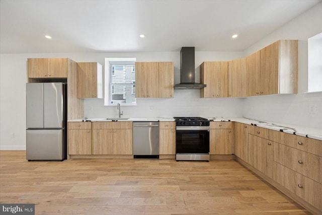 4063 Spring Garden St, Philadelphia, PA 19104 - kitchen with appliances with stainless steel finishes, wall chimney range hood, light brown cabinetry, light wood-style flooring, and recessed lighting