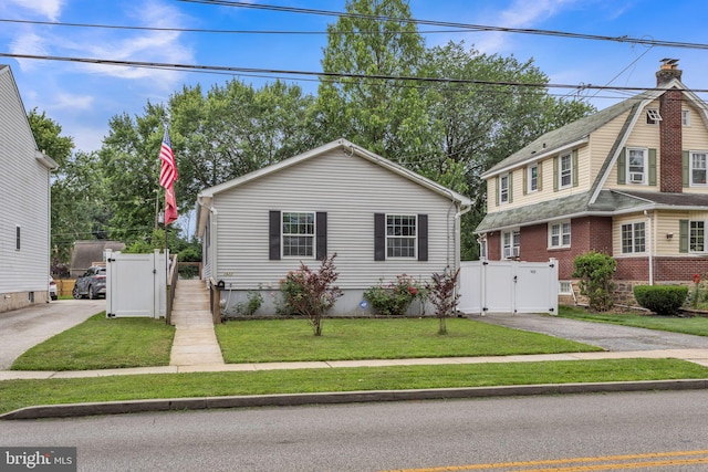 1622 Amosland Rd, Prospect Park, PA 19076 - view of front facade featuring a gate and asphalt driveway