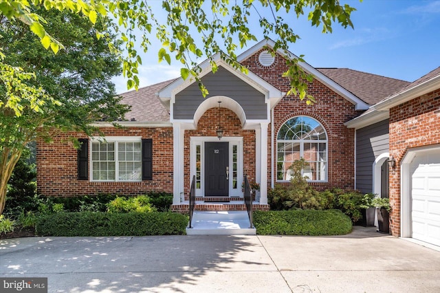 112 W Shore Dr, Milton, DE 19968 - traditional-style house featuring brick siding, concrete driveway, a shingled roof, and an attached garage