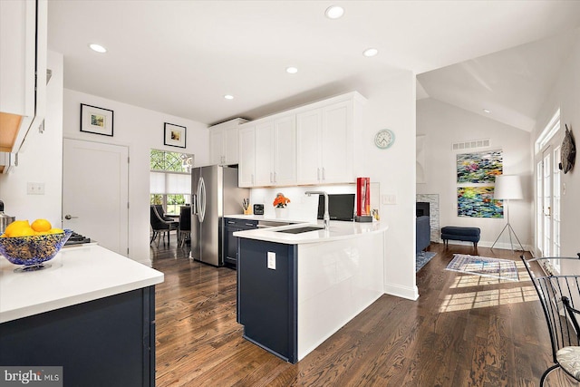 112 W Shore Dr, Milton, DE 19968 - kitchen with dark wood finished floors, a peninsula, white cabinetry, light countertops, and lofted ceiling
