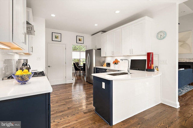112 W Shore Dr, Milton, DE 19968 - kitchen featuring freestanding refrigerator, dark wood-style floors, light countertops, white cabinets, and a peninsula