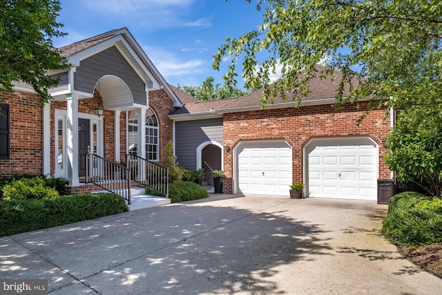 112 W Shore Dr, Milton, DE 19968 - view of front of house with a garage, brick siding, concrete driveway, and a shingled roof