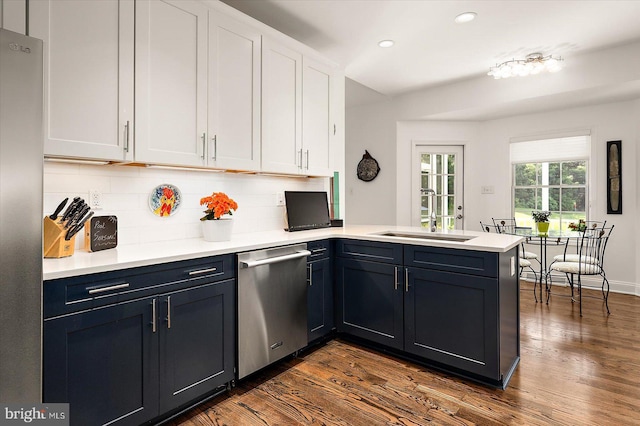 112 W Shore Dr, Milton, DE 19968 - kitchen with stainless steel appliances, a peninsula, white cabinets, decorative backsplash, and recessed lighting