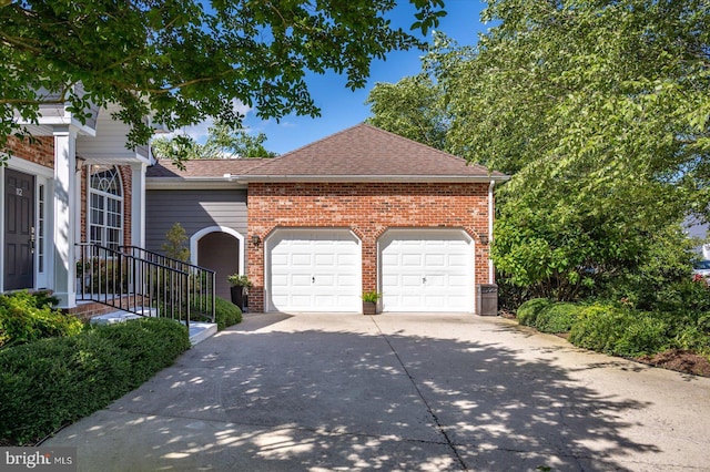 112 W Shore Dr, Milton, DE 19968 - view of front of property featuring a garage, concrete driveway, roof with shingles, and brick siding