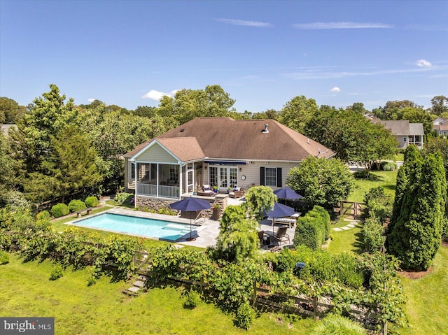 112 W Shore Dr, Milton, DE 19968 - back of house featuring a sunroom, a patio area, an outdoor pool, and outdoor dining area