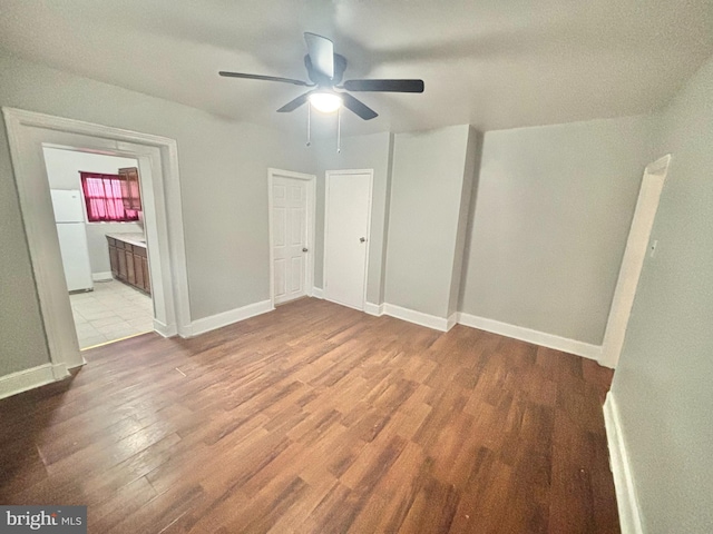 5803 Old Second St, Philadelphia, PA 19120 - unfurnished bedroom featuring freestanding refrigerator, wood finished floors, connected bathroom, and ceiling fan