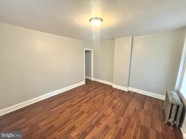 5803 Old Second St, Philadelphia, PA 19120 - unfurnished room featuring radiator heating unit and dark wood-style flooring