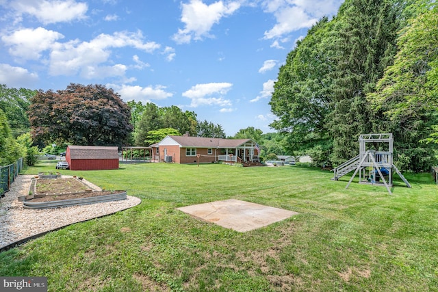 3508 Garrett Ct, Aberdeen, MD 21001 - view of yard with a shed, a vegetable garden, a playground, and view of wooded area