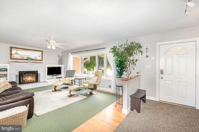 3508 Garrett Ct, Aberdeen, MD 21001 - living room with a glass covered fireplace, ceiling fan, and wood finished floors