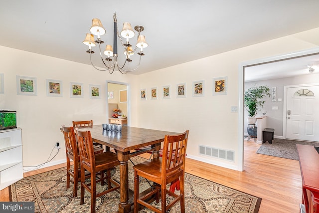 3508 Garrett Ct, Aberdeen, MD 21001 - dining area with a chandelier and light wood finished floors