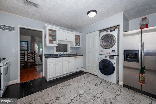 100 Garrett Rd, Glen Burnie, MD 21060 - washroom featuring stacked washing machine and dryer and a textured ceiling