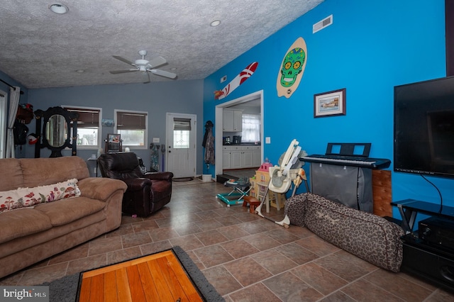 100 Garrett Rd, Glen Burnie, MD 21060 - living room with lofted ceiling, ceiling fan, stone finish floors, and a textured ceiling