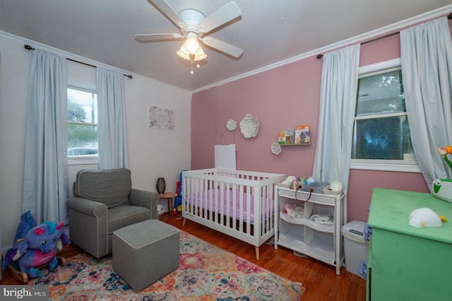 100 Garrett Rd, Glen Burnie, MD 21060 - bedroom featuring a nursery area, wood finished floors, crown molding, and ceiling fan