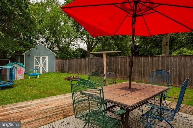 100 Garrett Rd, Glen Burnie, MD 21060 - deck featuring a storage unit, a fenced backyard, a trampoline, and outdoor dining area