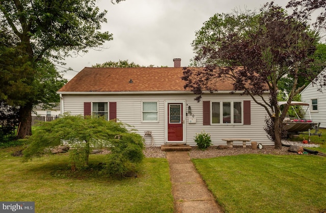 100 Garrett Rd, Glen Burnie, MD 21060 - view of front of home with a front yard, a chimney, and a shingled roof