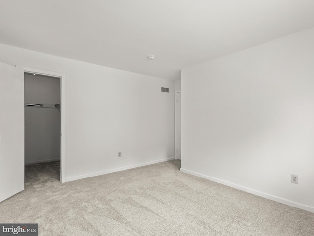398 Lynetree Dr Unit 11-D, West Chester, PA 19380 - unfurnished bedroom featuring carpet flooring, a walk in closet, and a closet