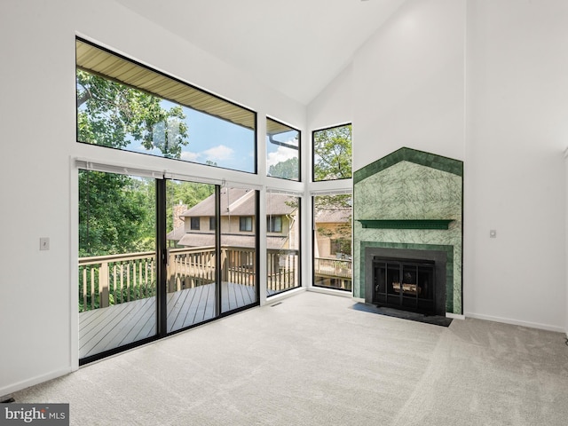 398 Lynetree Dr Unit 11-D, West Chester, PA 19380 - unfurnished living room featuring high vaulted ceiling, carpet flooring, and a fireplace with flush hearth
