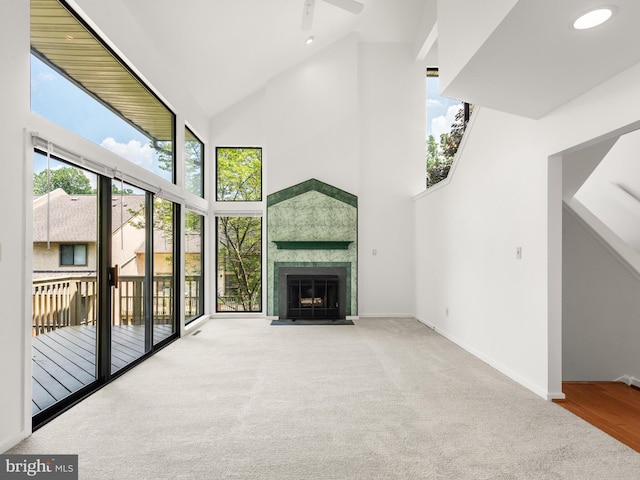 398 Lynetree Dr Unit 11-D, West Chester, PA 19380 - unfurnished living room featuring a high ceiling, carpet floors, a ceiling fan, and a fireplace with flush hearth