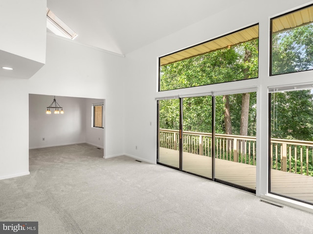398 Lynetree Dr Unit 11-D, West Chester, PA 19380 - carpeted spare room featuring healthy amount of natural light, a chandelier, and high vaulted ceiling