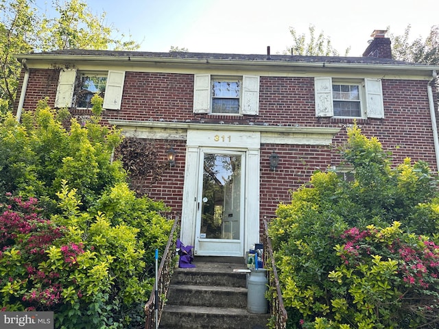 311 Ellsworth Dr, Silver Spring, MD 20910 - view of front of house featuring brick siding and a chimney