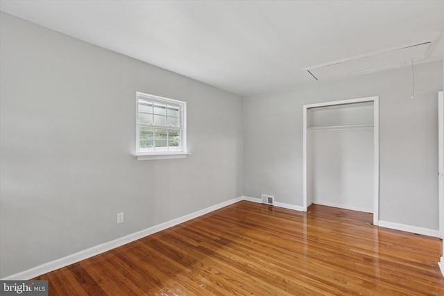 209 Riverview Rd, King Of Prussia, PA 19406 - unfurnished bedroom featuring attic access, wood finished floors, and a closet
