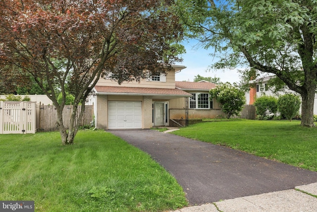 209 Riverview Rd, King Of Prussia, PA 19406 - split level home with brick siding, an attached garage, asphalt driveway, and a gate