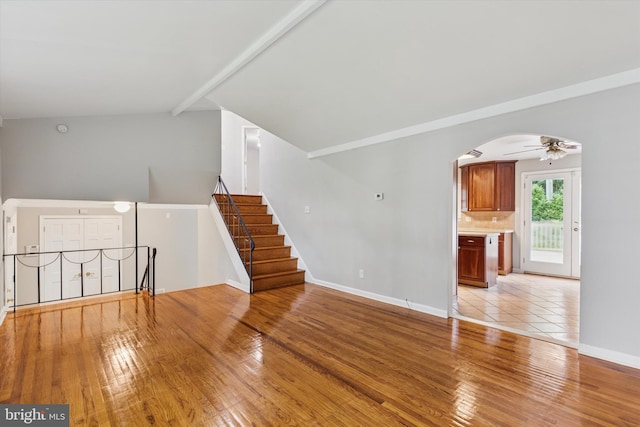 209 Riverview Rd, King Of Prussia, PA 19406 - unfurnished living room featuring light wood-style floors, arched walkways, ceiling fan, and lofted ceiling