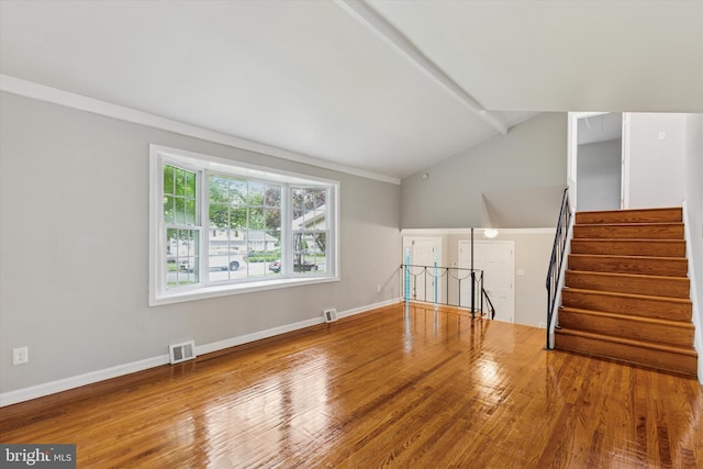 209 Riverview Rd, King Of Prussia, PA 19406 - unfurnished living room with vaulted ceiling, wood finished floors, and stairway