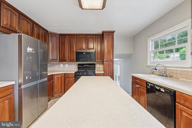 209 Riverview Rd, King Of Prussia, PA 19406 - kitchen featuring black appliances, backsplash, light countertops, and light tile patterned flooring