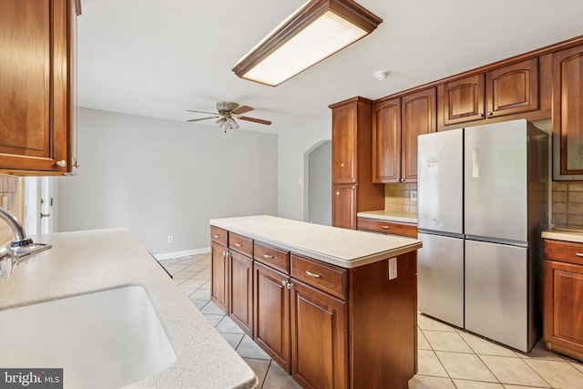 209 Riverview Rd, King Of Prussia, PA 19406 - kitchen featuring freestanding refrigerator, light tile patterned flooring, decorative backsplash, a ceiling fan, and light countertops