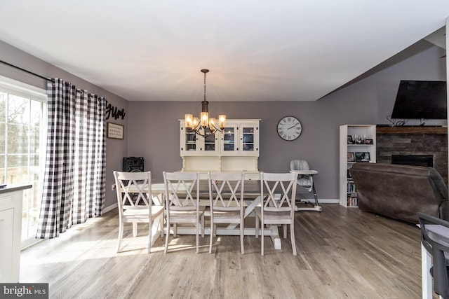 5 N Edinburgh Ct, Houston, DE 19954 - dining space with a chandelier, wood finished floors, and a fireplace