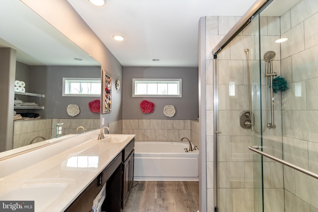 5 N Edinburgh Ct, Houston, DE 19954 - bathroom featuring a bath, double vanity, a stall shower, wood finished floors, and recessed lighting