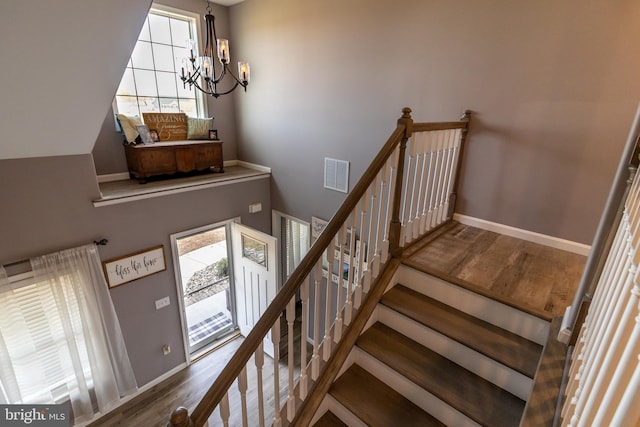 5 N Edinburgh Ct, Houston, DE 19954 - stairs featuring a chandelier and wood finished floors