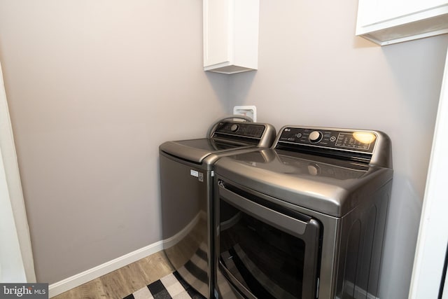 5 N Edinburgh Ct, Houston, DE 19954 - washroom featuring cabinet space, separate washer and dryer, and light wood-style floors