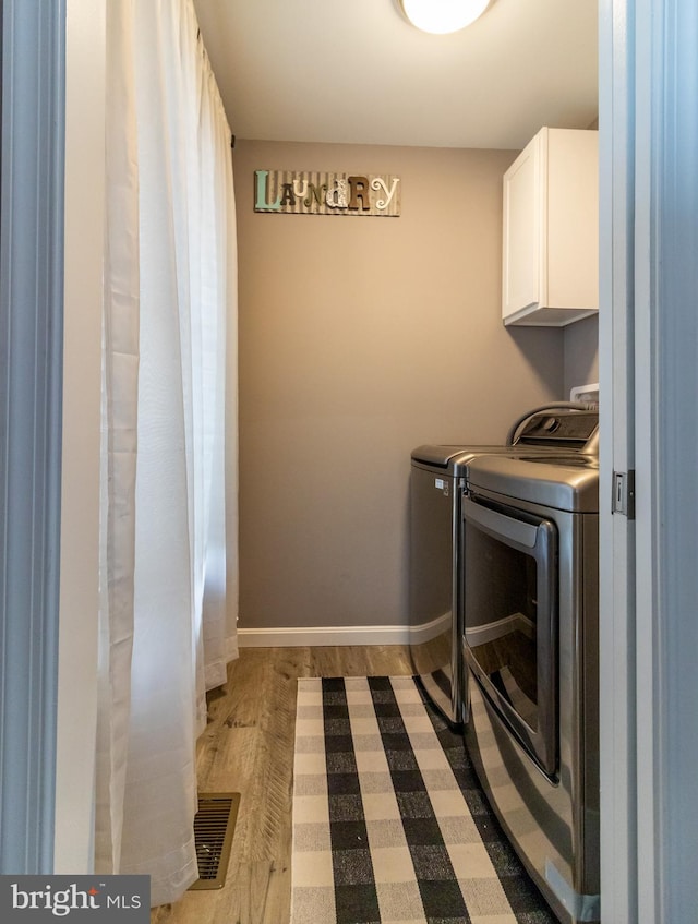 5 N Edinburgh Ct, Houston, DE 19954 - laundry room with cabinet space, separate washer and dryer, and wood finished floors