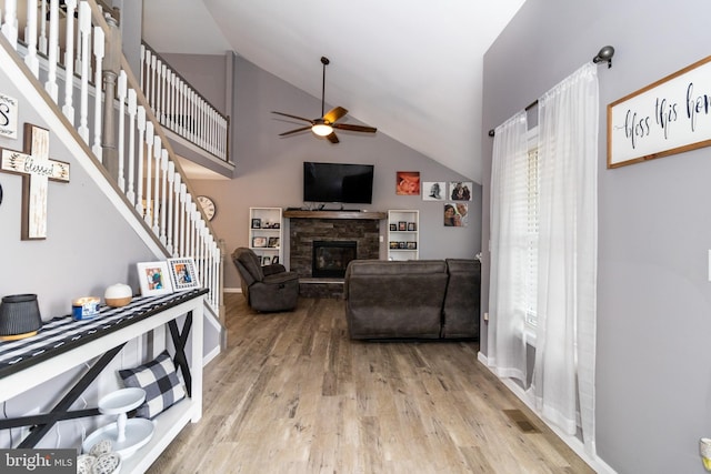 5 N Edinburgh Ct, Houston, DE 19954 - living room with a ceiling fan, a fireplace, wood finished floors, high vaulted ceiling, and stairs