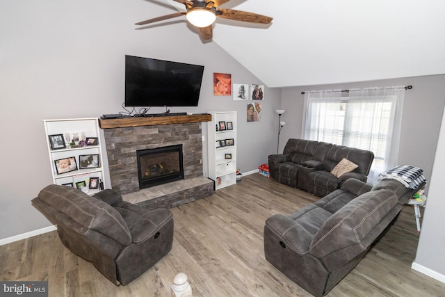 5 N Edinburgh Ct, Houston, DE 19954 - living room with lofted ceiling, a ceiling fan, wood finished floors, and a stone fireplace