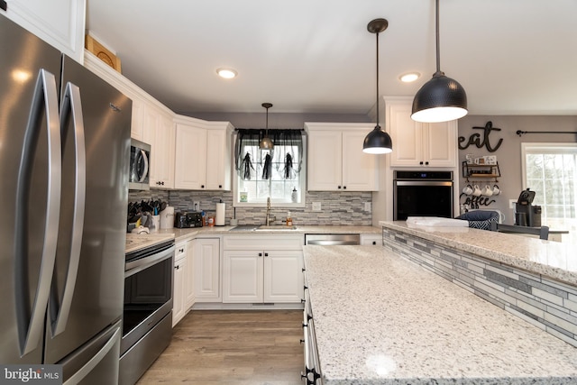 5 N Edinburgh Ct, Houston, DE 19954 - kitchen with stainless steel appliances, decorative backsplash, recessed lighting, white cabinets, and light wood-type flooring