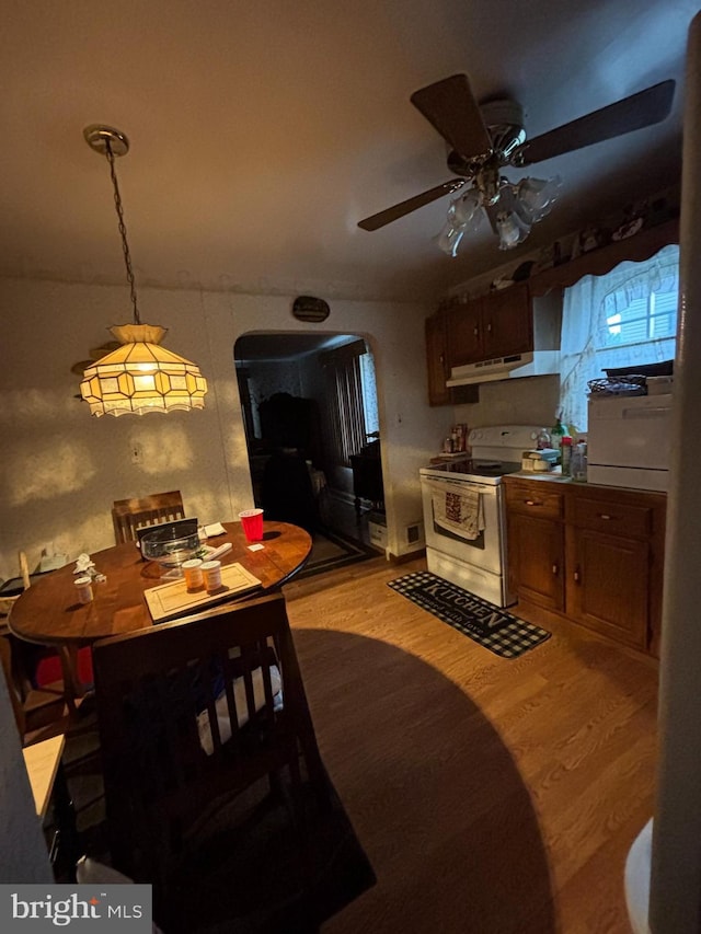 339 W Brookhaven Rd, Brookhaven, PA 19015 - kitchen with white range with electric stovetop, arched walkways, light wood-type flooring, ceiling fan, and under cabinet range hood