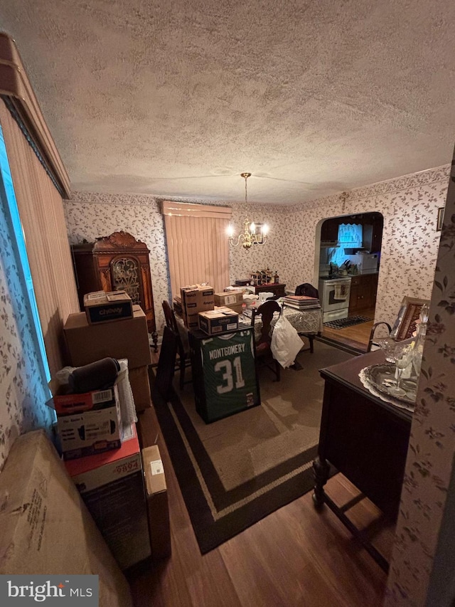 339 W Brookhaven Rd, Brookhaven, PA 19015 - dining space featuring wallpapered walls, a textured ceiling, a chandelier, and wood finished floors