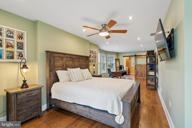 130 E State St, Media, PA 19063 - bedroom featuring a barn door, wood finished floors, and recessed lighting