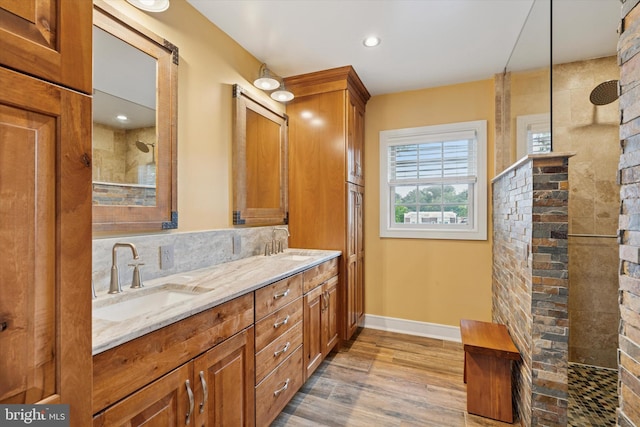 130 E State St, Media, PA 19063 - bathroom featuring walk in shower, double vanity, and wood finished floors