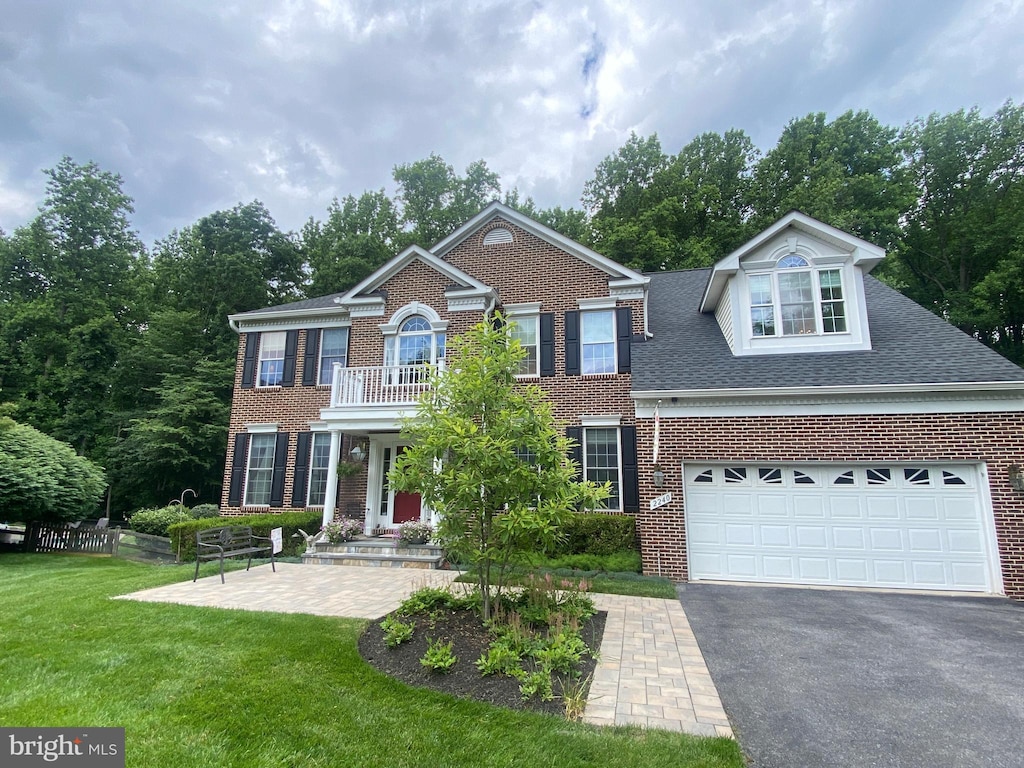 2240 Ballard Way, Ellicott City, MD 21042 - colonial-style house with brick siding, driveway, a front lawn, and a balcony